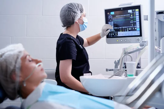 Dental care professional treating patient